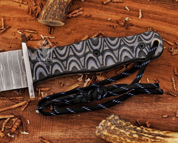 Outdoor shot of Damascus big dagger knife – black Micarta grip