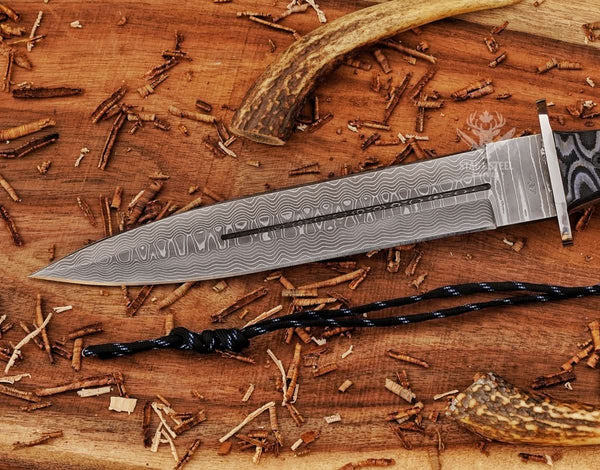 Close-up of black Micarta handle on big Damascus dagger