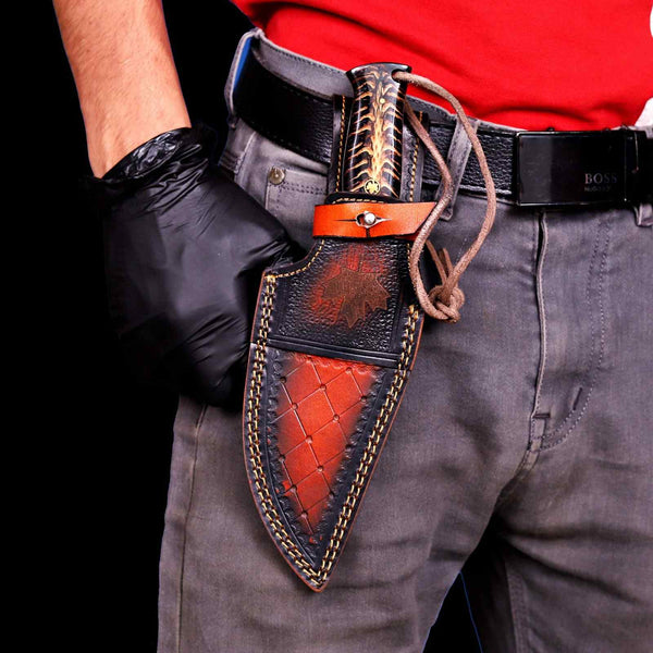 Damascus hunting knife worn on belt in vertical carry leather sheath