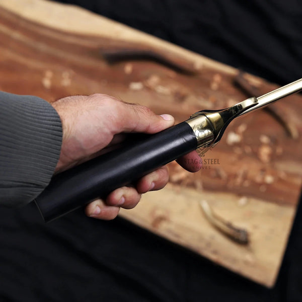 Close-up of polished brass scrolled S-guard on Alamo Musso bowie knife