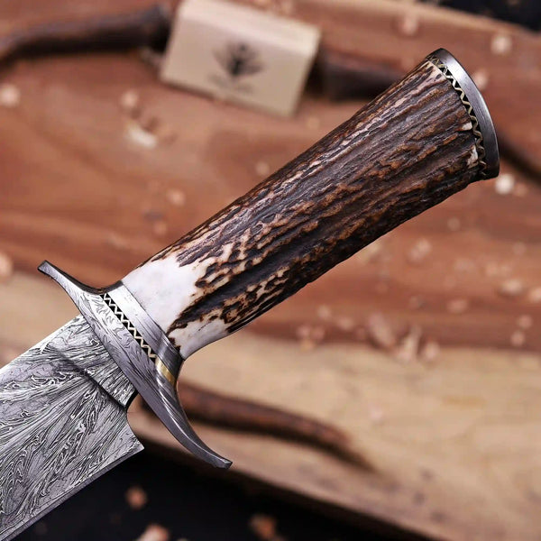 Antler horn grip with steel pommel cap on Masonic Feather Damascus bowie knife