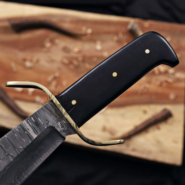 Brass S-guard and black G10 handle on a Damascus bowie knife