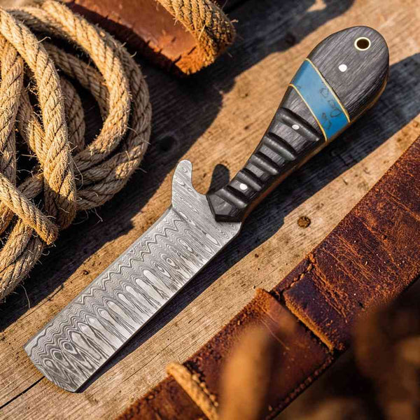 Knife with a wooden handle on a wooden surface next to rope
