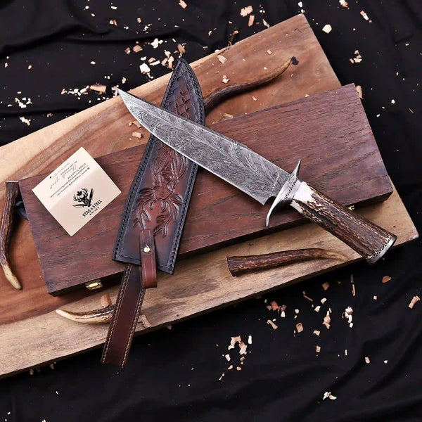 Collector grade Feather Damascus bowie knife displayed at an angle with wooden store box