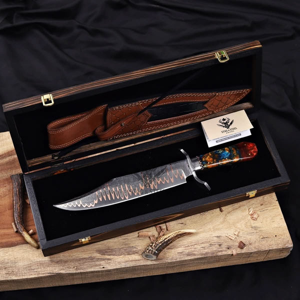 copper Damascus Bowie knife displayed with leather sheath in a wooden box
