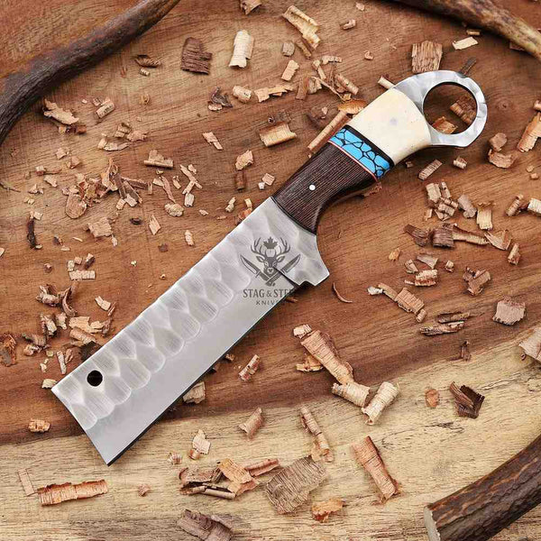 Decorative knife with a wooden handle on a wooden surface with wood shavings.