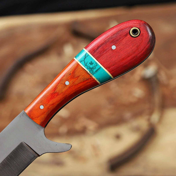 Knife with a red and wood handle on a blurred background