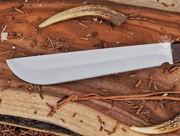 D2 machete knife with satin blade and Ironwood handle displayed on rustic wood with paracord