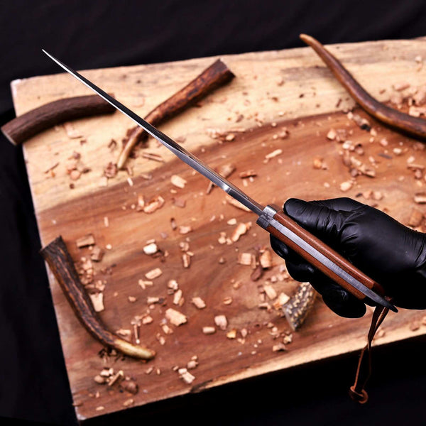 Spine and clip point of a VG10 Damascus bowie blade