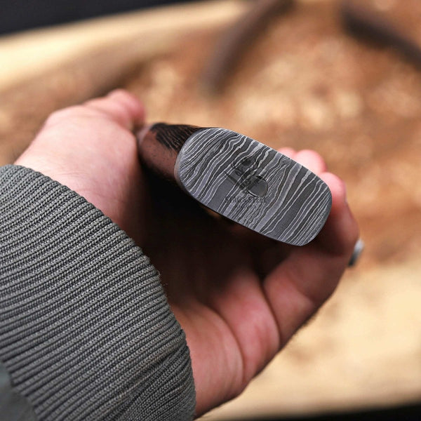 Damascus steel pommel and wenge handle detail on handmade bowie knife
