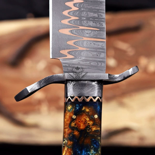 Damascus guard detail on copper Damascus Bowie knife
