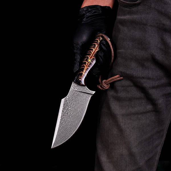 Stainless Damascus hunting knife with pine cone handle and leather lanyard