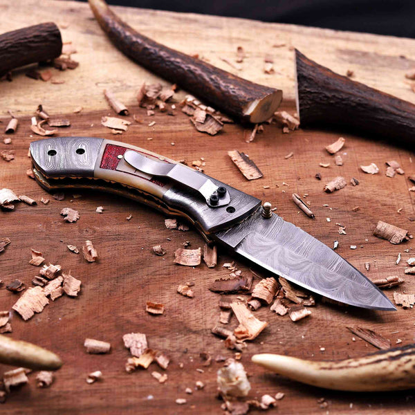 Damascus pocket knife with stainless steel pocket clip and handmade folding design