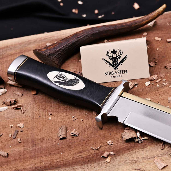 Hand-engraved camel bone scrimshaw inlay of the Expendables skull and crow emblem