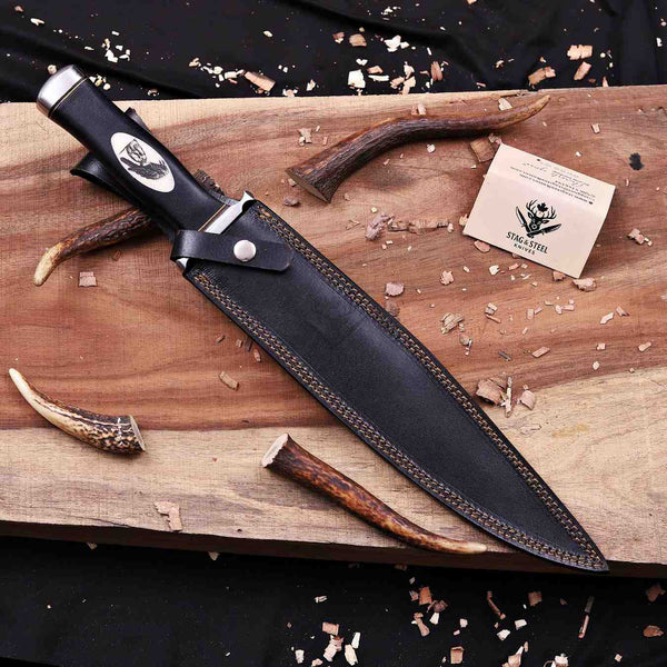 Expendables toothpick bowie knife seated in brown leather sheath with belt loop