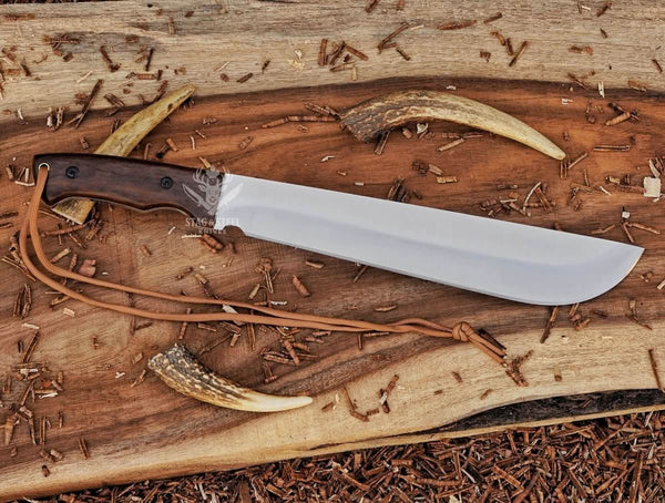 Full tang D2 machete knife with Ironwood handle, satin blade, and paracord on wood background