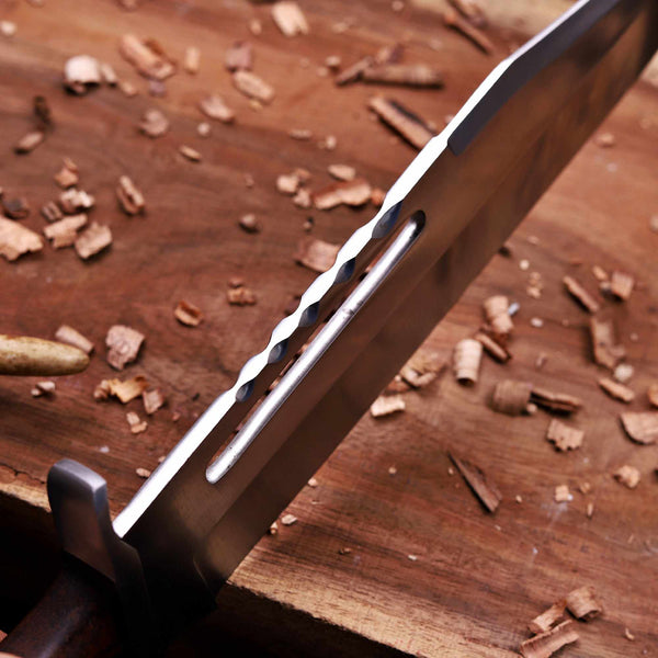Hand-forged D2 bowie knife sawback spine and fuller close-up