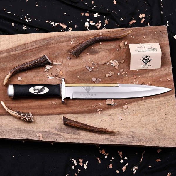 Handmade Expendables toothpick bowie knife with brass spine on wooden board