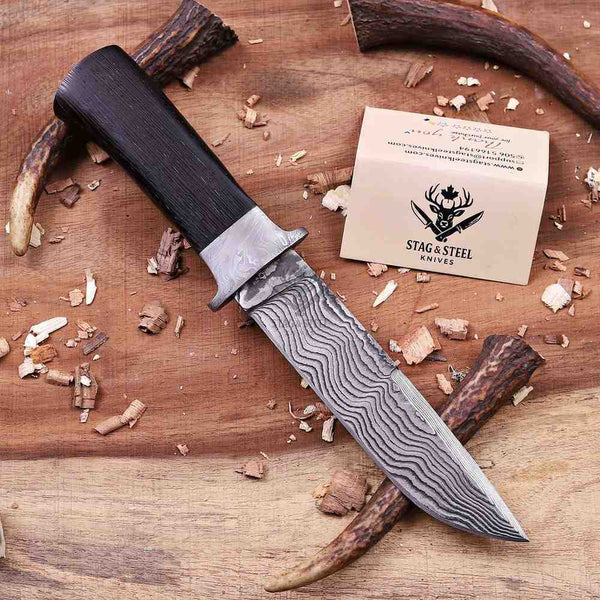 Handmade VG10 Damascus hunting knife displayed diagonally with brand card