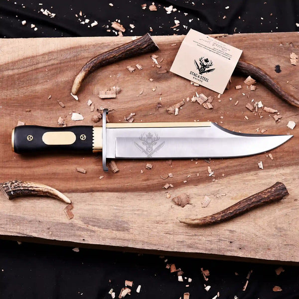 Full profile of Iron Mistress D2 bowie knife with brass spine on wooden board