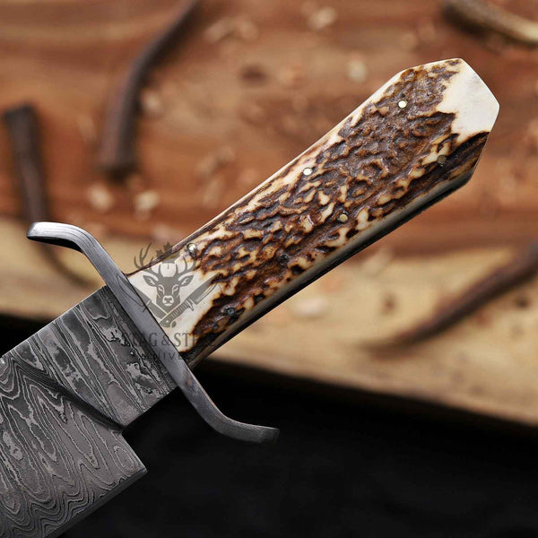 Close-up of the natural stag antler handle with pins and Damascus guard