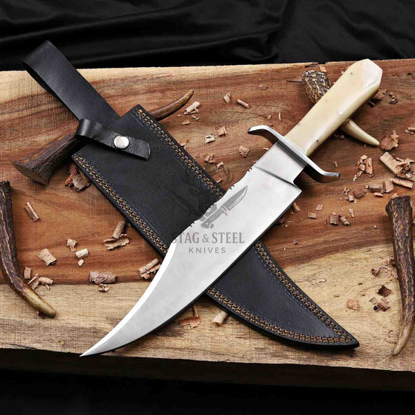 D2 Bowie knife and black leather sheath crossed on a wooden plank
