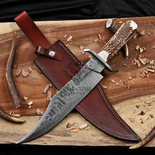 Juan Padillo Damascus Bowie knife and brown leather sheath crossed on a wooden plank