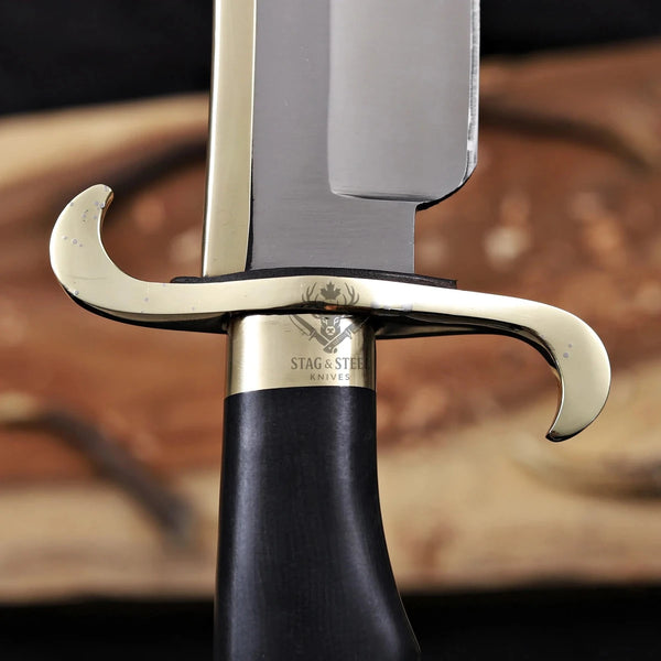 Black G10 handle and brass guard detail of handmade Musso bowie knife
