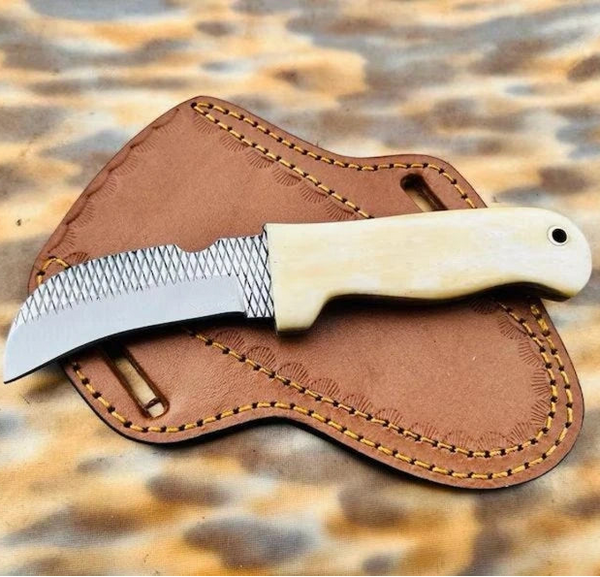 Polished cream bone handle with pinned construction on a rasp steel hawkbill knife