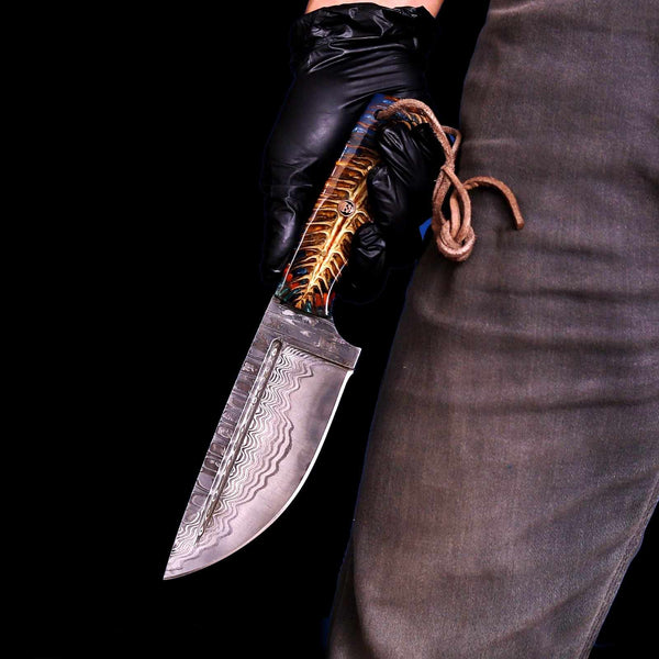 San Mai Damascus hunting knife with pine cone handle held in hand