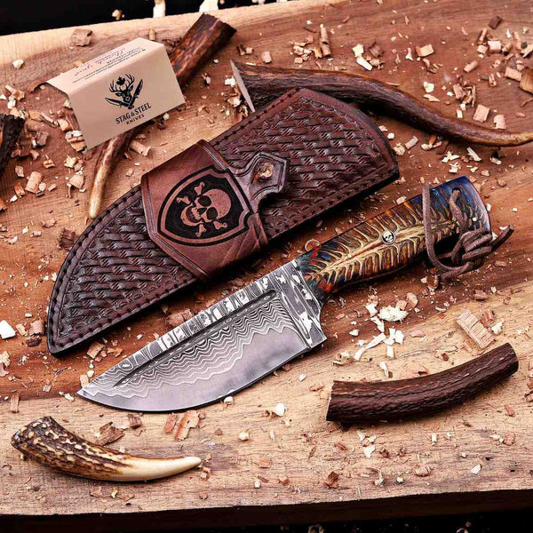 Handmade San Mai Damascus hunting knife with pine cone handle and skull leather sheath