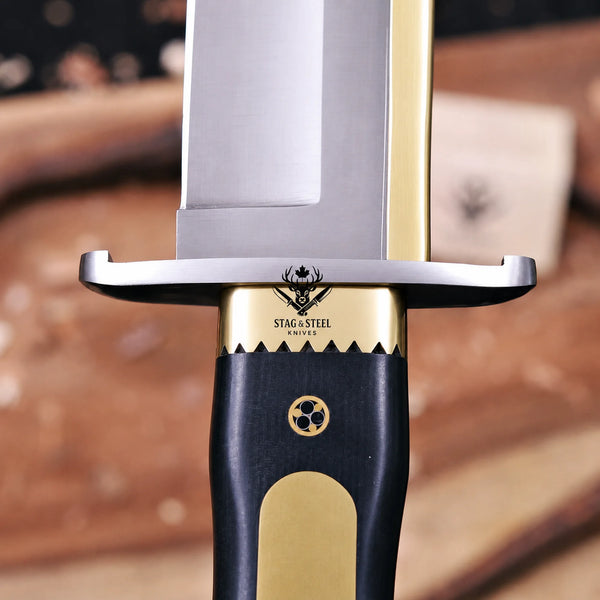 Sawtooth brass bolster and stainless steel guard macro on Iron Mistress bowie knife