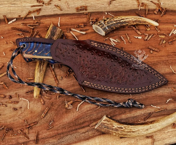 Damascus skinning knife with protective leather sheath