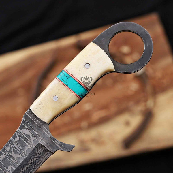 Decorative knife with a detailed handle on a wooden surface