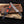 Premium Cu-Mai Copper Damascus Bowie knife featuring a striking raindrop pattern, copper guard, and textured dark handle with custom leather sheath
