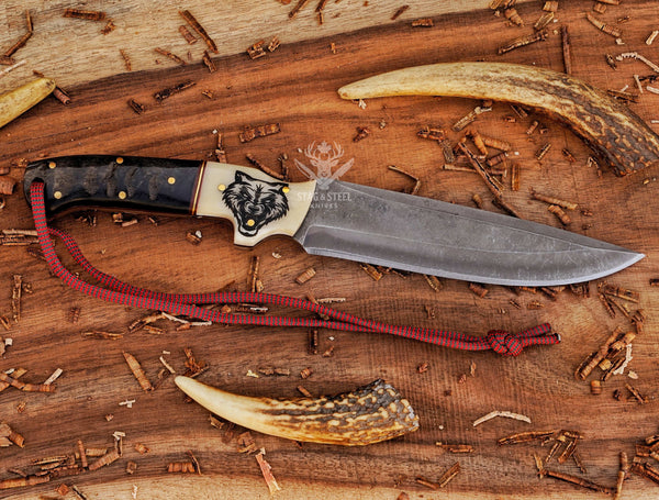 Custom D2 hunting knife with wolf engraved handle and leather sheath