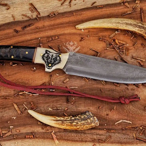 Custom D2 hunting knife with wolf engraved handle and leather sheath