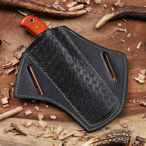 Black leather axe sheath with orange handle on a wooden background