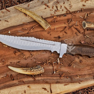 D2 rasp steel bowie knife with walnut handle on rustic wood with antlers