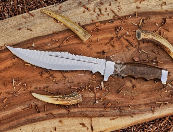D2 rasp steel bowie knife with walnut handle on rustic wood with antlers