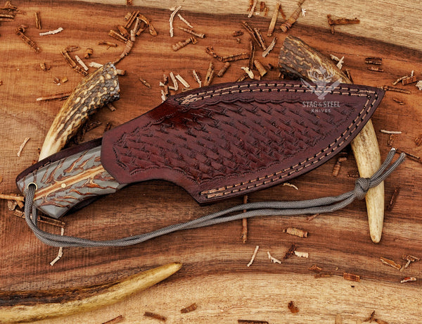 D2 skinning knife designed for deer hunting with pinecone handle grip