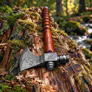 Damascus steel bushcraft axe featuring a handcrafted wood handle
