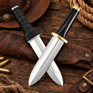 Two stainless steel hunting knives with black handles and brass guards crossed over a brown leather sheath on a rustic wooden surface