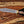 Damascus bowie knife with walnut handle and brass guard held in hand