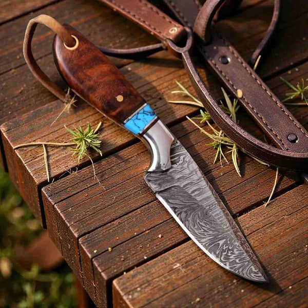 Handcrafted Damascus steel hunting knife featuring a walnut wood handle, turquoise spacer, and leather lanyard on a rustic wooden table.