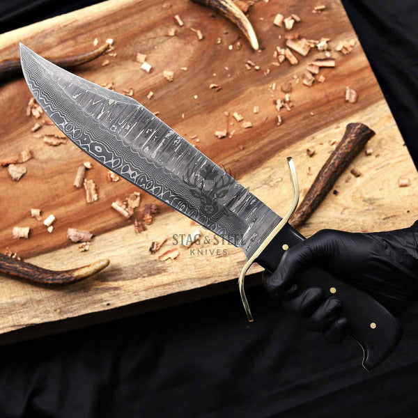 Handmade Damascus western bowie knife held in hand
