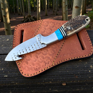Knife with a brown leather sheath in a forest setting