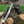 Knife with a decorative blade and leather sheath on a wooden log