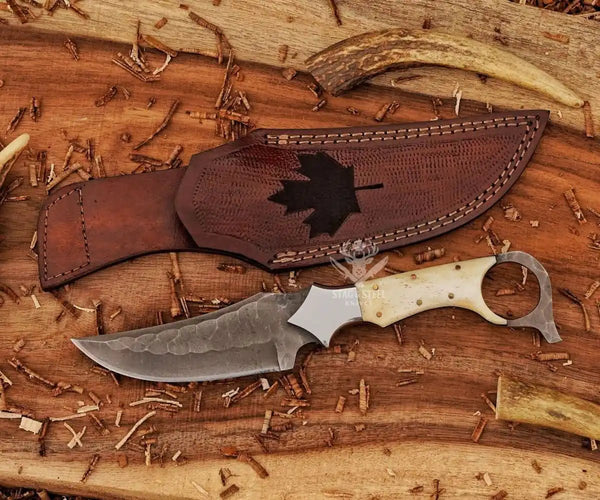 Maple leaf engraved leather sheath paired with custom ringtail knife