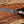 Outdoor D2 hunting knife with leather sheath on wooden surface